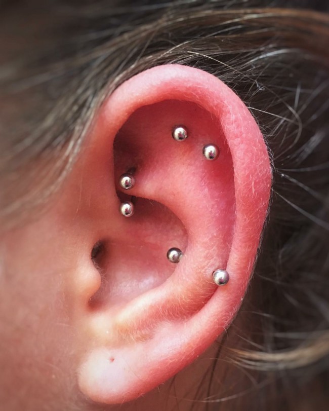 stylish rook, snug and flat piercings done with matching earrings for a modern feel
