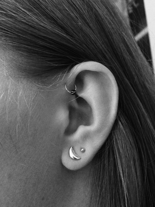 trendy ear styling with two lobe piercings and a hoop in the forward helix is very edgy