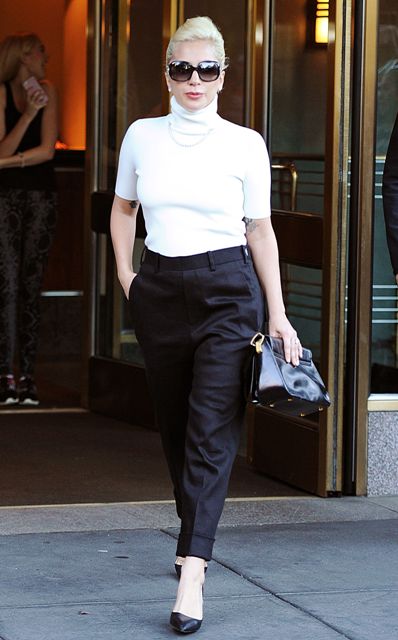With black high-waisted trousers, black clutch and pumps