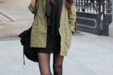 With black scarf, black mini skirt, olive green jacket and bag