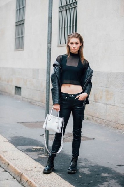 With crop top, black jacket, white bag and leather trousers