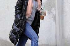 With gray hoodie, black puffer coat, jeans and beige boots