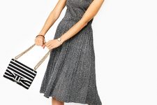 With gray pleated dress and silver pumps