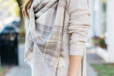 With gray sweater, white pants and plaid scarf