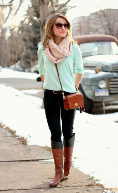 With mint green sweater, black trousers, black and brown high boots and brown bag