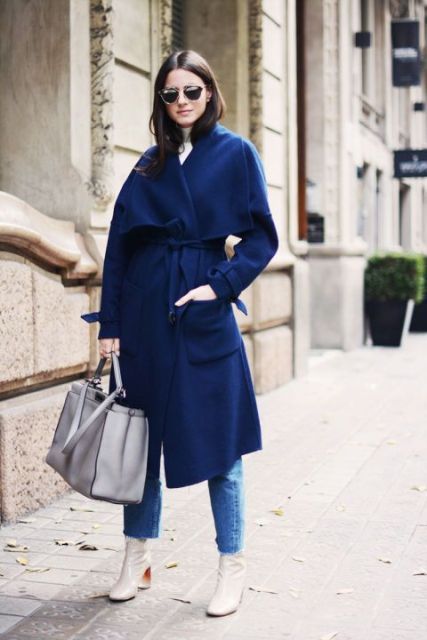 With navy blue midi coat, cropped jeans, white turtleneck and gray tote bag