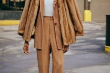 With striped blazer, fur jacket, white turtleneck and beige shoes