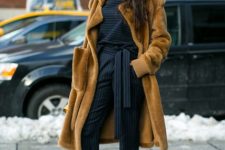 With striped shirt, brown fur coat and beige shoes
