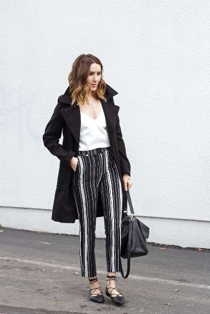 With white V neck top, black coat, black bag and lace up flat shoes