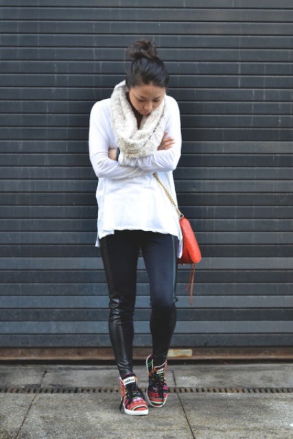 With white cardigan, black leather leggings, red bag and colorful sneakers