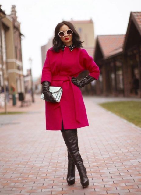 With white clutch, black leather gloves and over the knee boots
