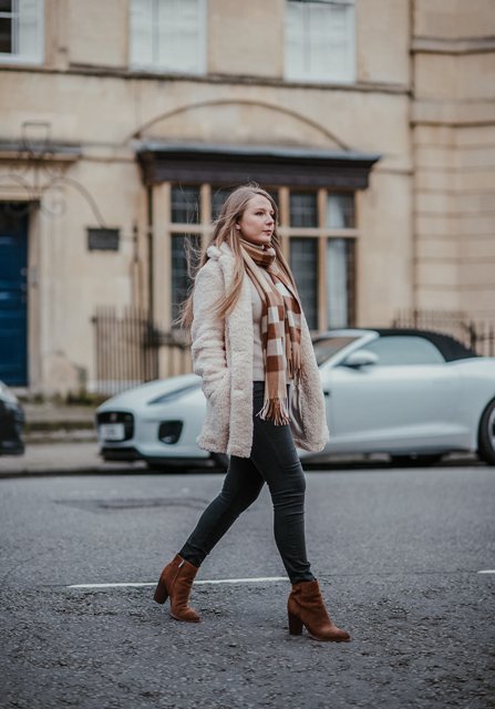 With white jacket, pants and brown suede ankle boots