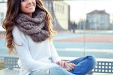 With white long sweater, distressed jeans and lace up boots