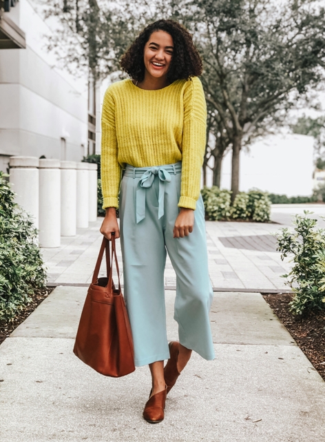 With yellow sweater, brown tote bag and brown mules
