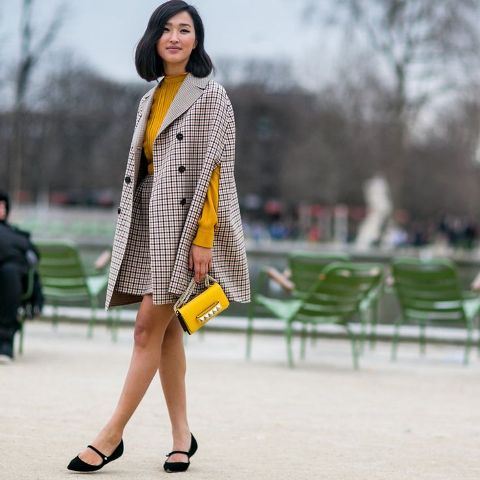 With yellow sweater, checked mini skirt, yellow mini bag and black flat shoes