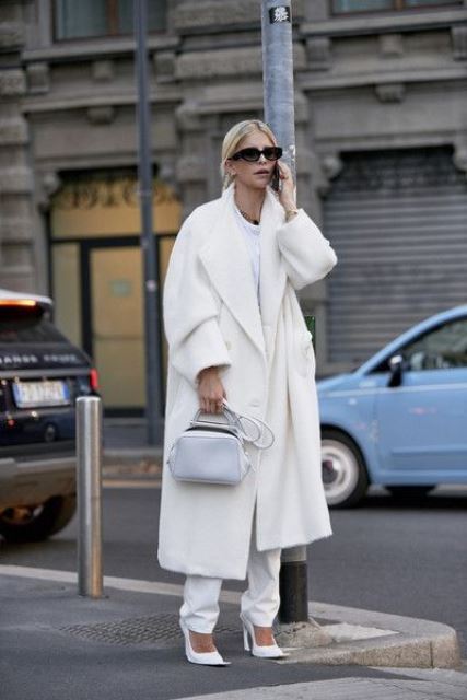 a beautiful monochromatic look with a white tee, white pants, a creamy midi coat, a white bag and shoes