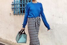 a blue long sleeve top, a tweed midi skirt, grey mules and a green bag for a colorful look
