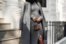 a grey midi sweater dress with a slit, black slingbacks, a grey midi coat and a printed bag