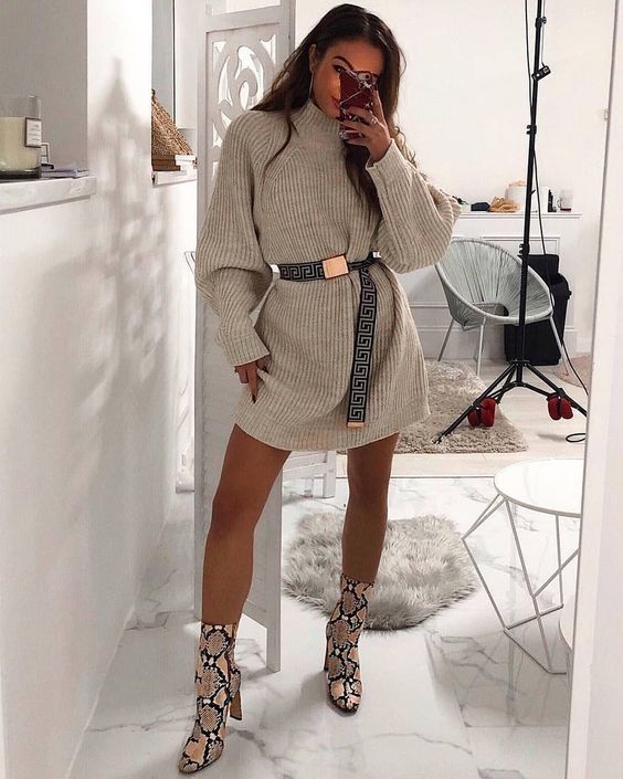 a neutral mini sweater dress, a printed belt, snakeskin boots for a trendy and edgy look