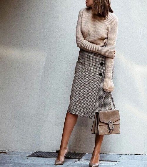 a neutral sweater, a tweed midi skirt with buttons, nude shoes, a tan suede bag for a winter work look