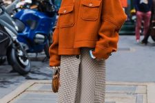 a neutral tweed midi skirt, neutral sock boots, a rust-colored oversized short coat and a brown bag