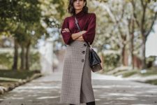 a purple turtleneck, a tweed midi skirt on buttons, black sock boots and a black bag for fall and winter