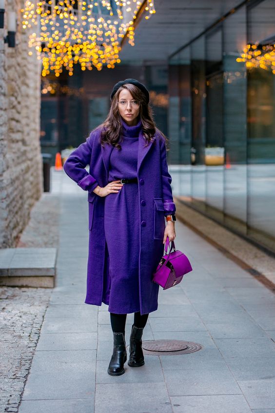 a super bold look with a purple sweater dress, a matching coat, a pink bag, black boots and a beret