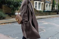 a total black look with a grey winter midi coat and a tan bag is stylish and timeless