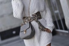 a white chunky knit sweater dress, a snakeskin belt, a grey bag and grey thigh high boots