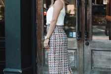 a white spaghetti strap top, a tweed midi skirt, nude shoes for a chic and girlish look