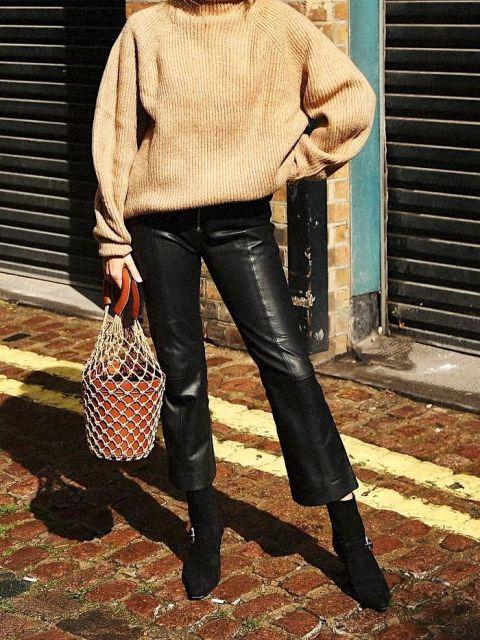 With beige loose sweater, fishnet bag and black suede boots