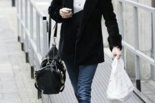 With black jacket, tote bag, jeans and sweater
