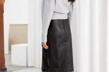 With black leather midi skirt and black ankle boots