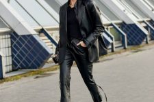 With black shirt, black leather blazer and high heeled boots