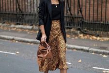 With black top, black long blazer, brown leather bag and white sneakers