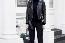 With black turtleneck, chain strap bag and black leather boots