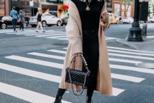 With black turtleneck, jeans, beige midi coat and chain strap bag