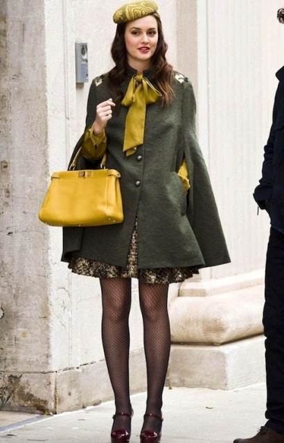 With mini dress, olive green cape coat, yellow bag and patent leather shoes