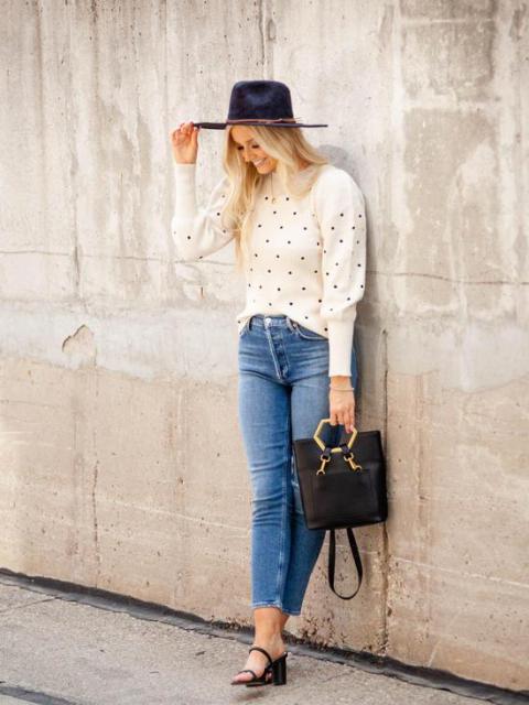 With navy blue hat, black bag, cropped jeans and black shoes