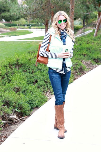 With striped shirt, plaid scarf, brown bag, jeans and brown high boots