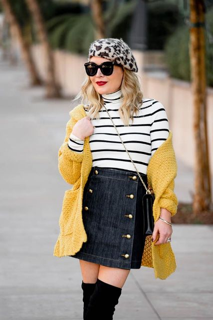 With striped turtleneck, denim mini skirt, yellow cardigan, chain strap bag and black over the knee boots
