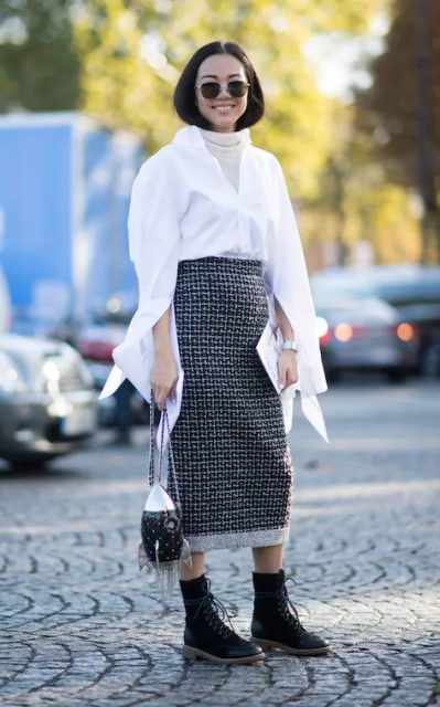With white long sleeved shirt, printed midi skirt and unique bag