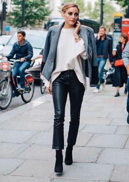 With white oversized sweater, gray blazer and ankle boots