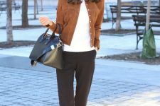 With white shirt, black cropped pants, black leather bag and flat shoes
