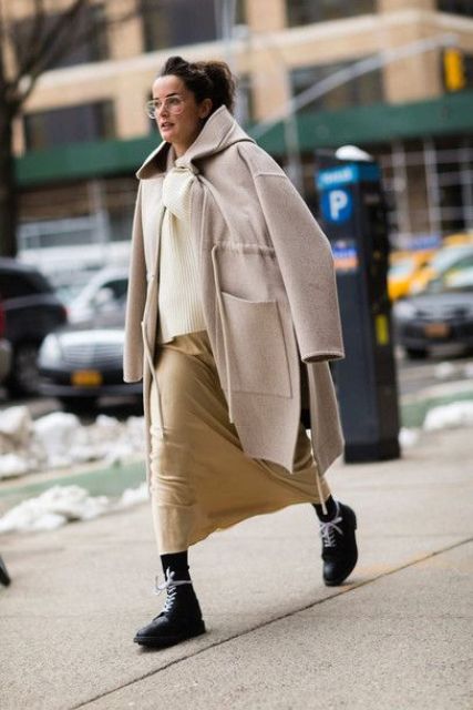 With white sweater, beige skirt and beige coat
