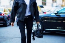 With white t-shirt, black leather jacket, black bag and flat shoes