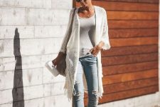 With white top, distressed jeans, beige bag and high heels