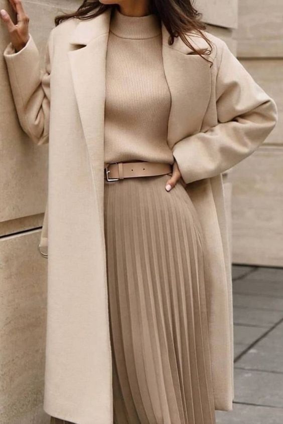 a beautiful look with a tan sweater, a matching pleated midi with a tan belt, a creamy coat is pure elegance