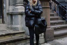 a black outfit with a puff coat, skinnies, Chelsea boots and an oversized backpack is chic