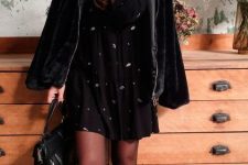 a black printed mini dress, black tights, combat boots, a shearling coat and a bag for a lovely girlish feel